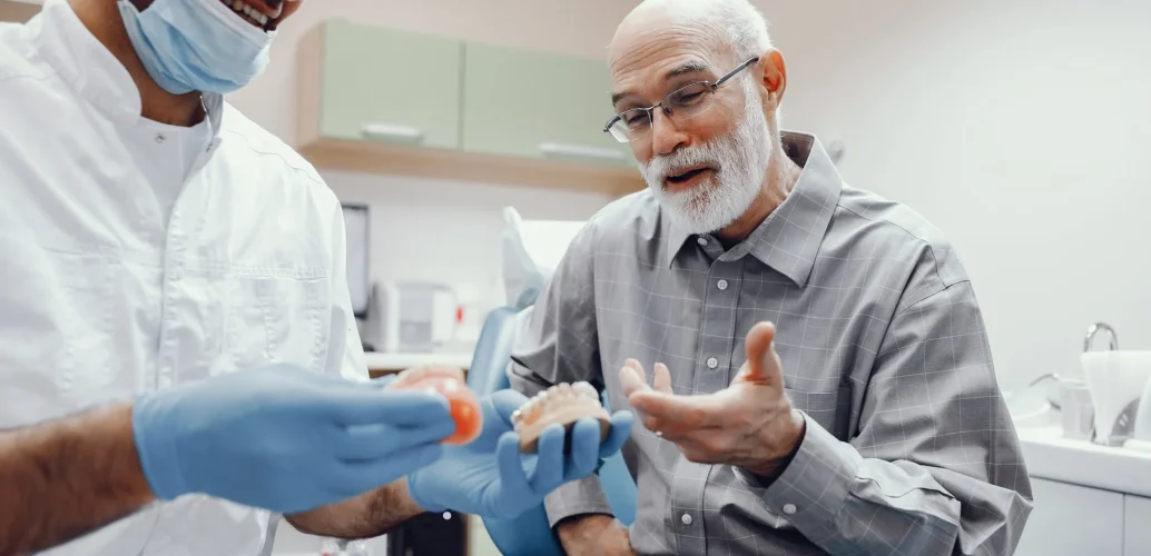 patiend and a dentist talking about dental implants